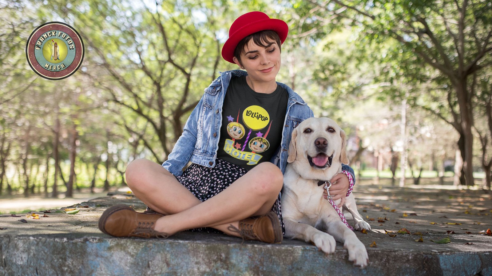 Woman wearing Lollipop Motel graphic tee while sitting with a dog outdoors